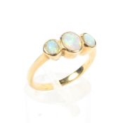 An unmarked yellow metal opal three stone ring. 3.4g. Size K.