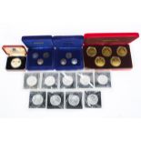 A collection of Isle of Man commemorative silver and white metal coin sets to include crowns and