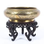 A late 19th/early 20th century Chinese bronze incense burner decorated with three shaped reserves