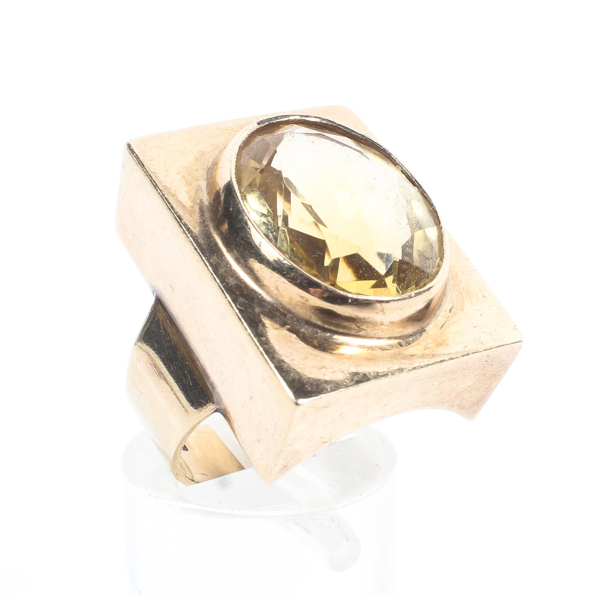 A 9ct gold panel ring set with an oval faceted citrine quartz estimated to weigh approximately 6.