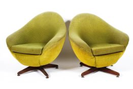 A pair of retro egg swivel chairs by Greeves and Thomas, circa 1960, upholstered in green fabric,