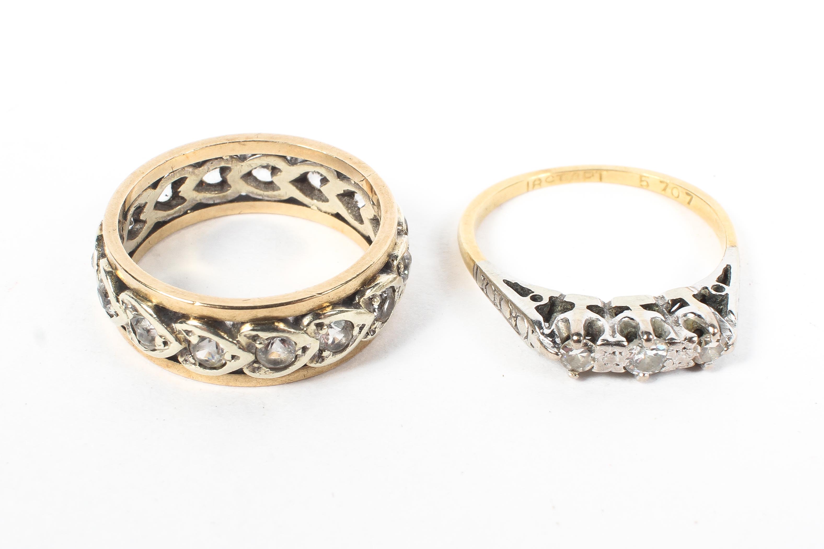 A 9ct gold three stone diamond ring together with a 9ct full eternity ring. 5.6g.