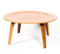 A contemporary round CTW coffee table after charles and eames having bentwood legs shaped table top