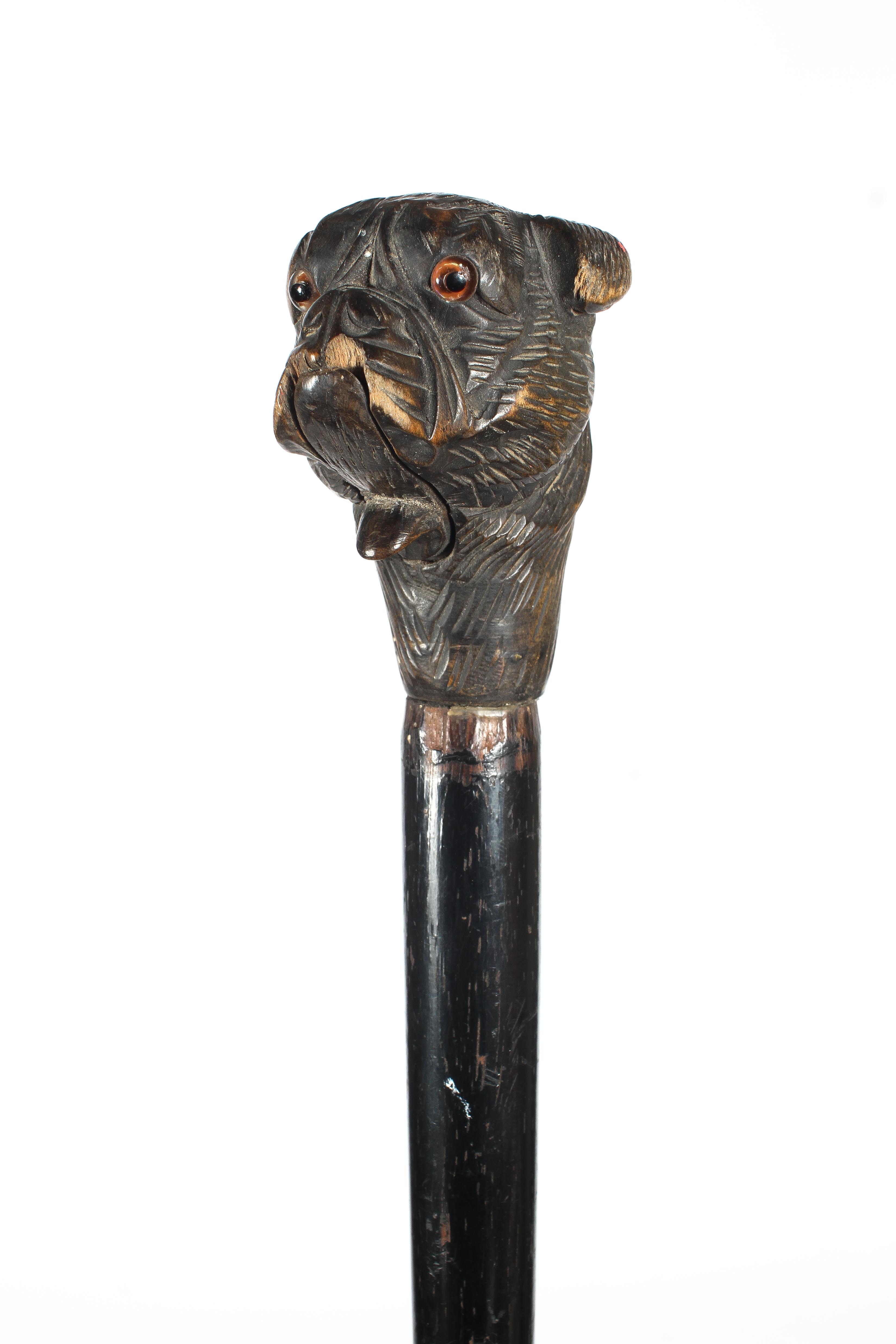 A carved ebonised walking stick, - Image 2 of 2