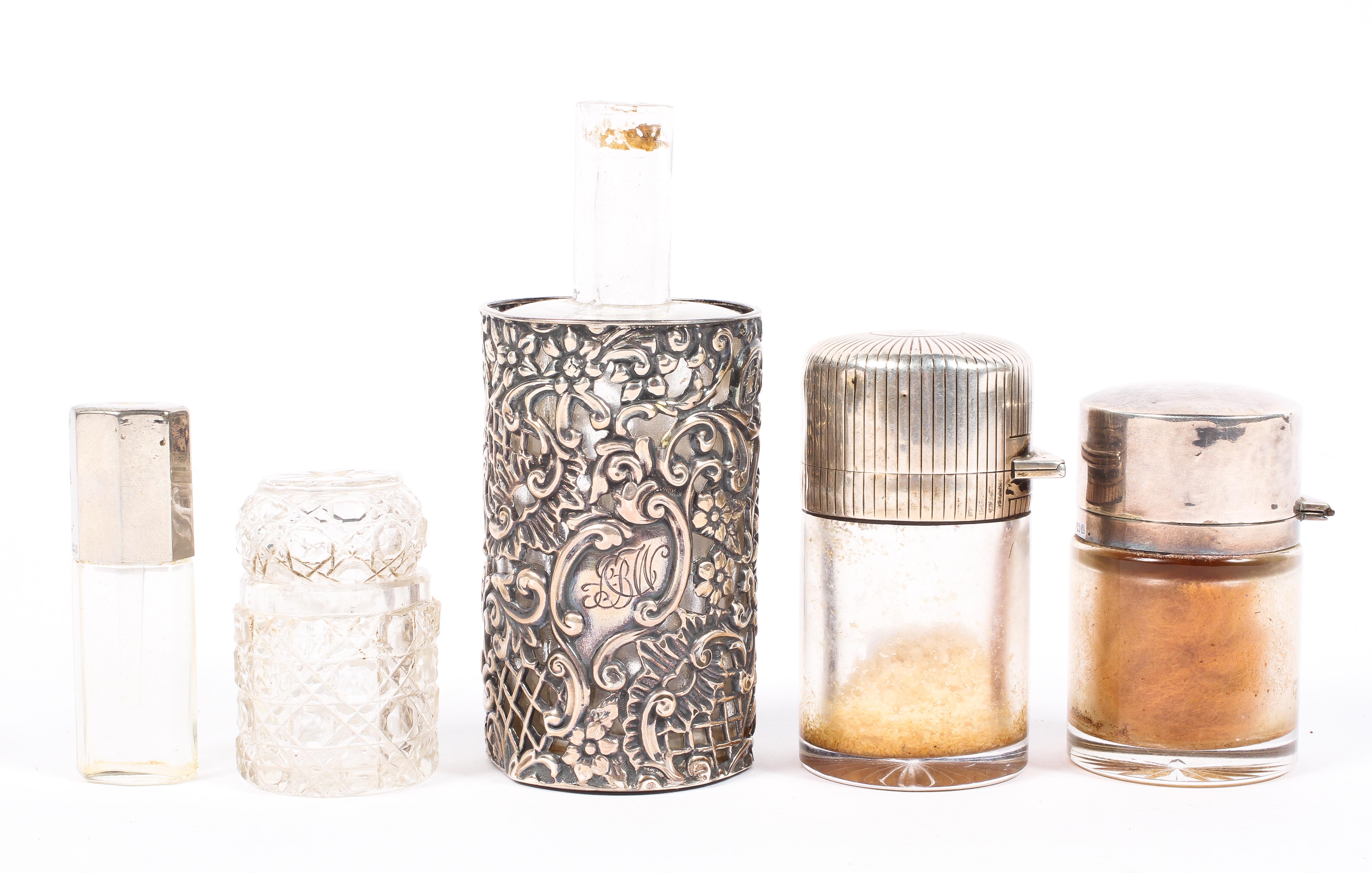 A collection of glass scent and other bottles with sterling silver mounts,