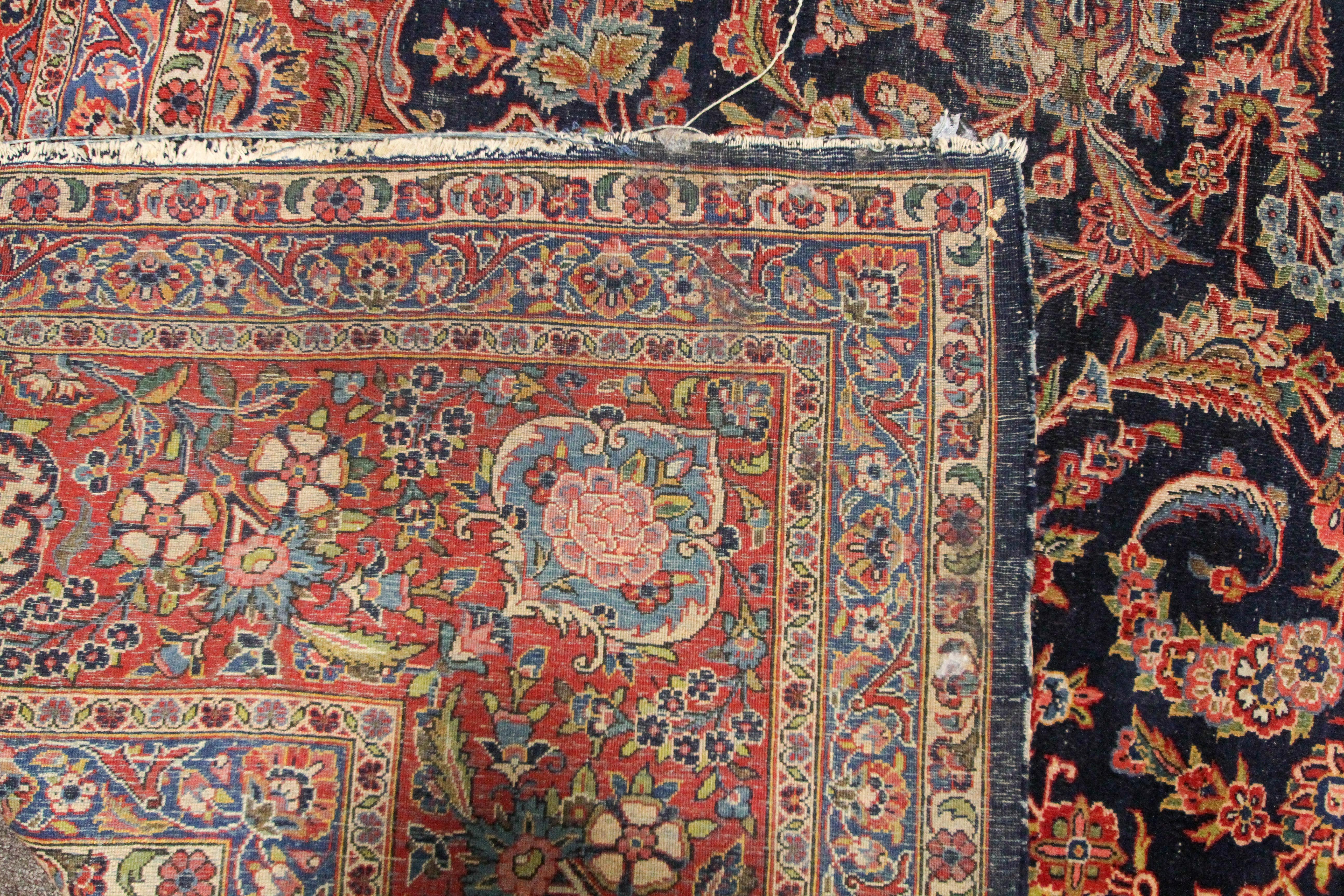 A large Persian silk/wool rug red ground with central floral panel and three floral; borders. - Image 3 of 3