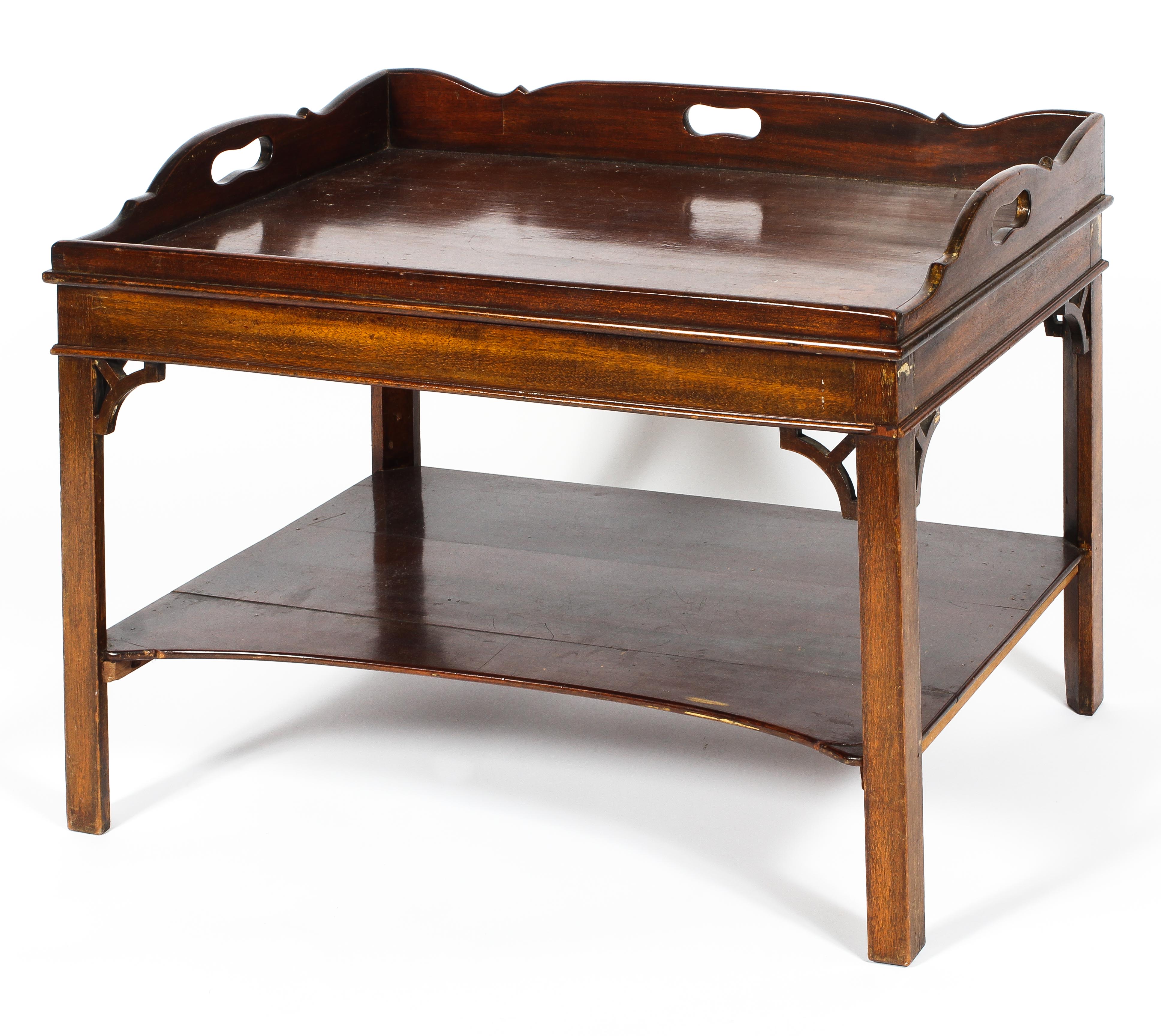 A Georgian mahogany butler's tray table, with pierced handles and scroll gallery,