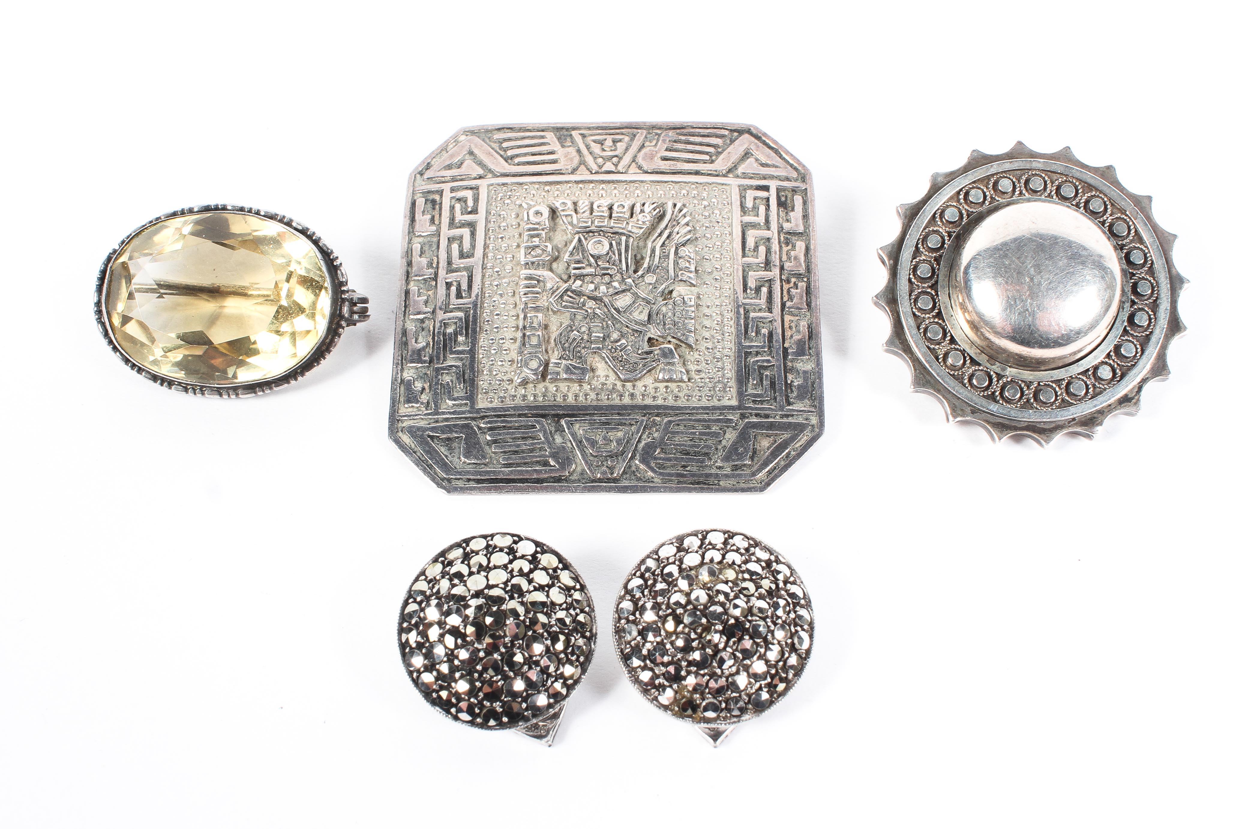 A collection of white metal and silver items to include a circular mourning brooch,