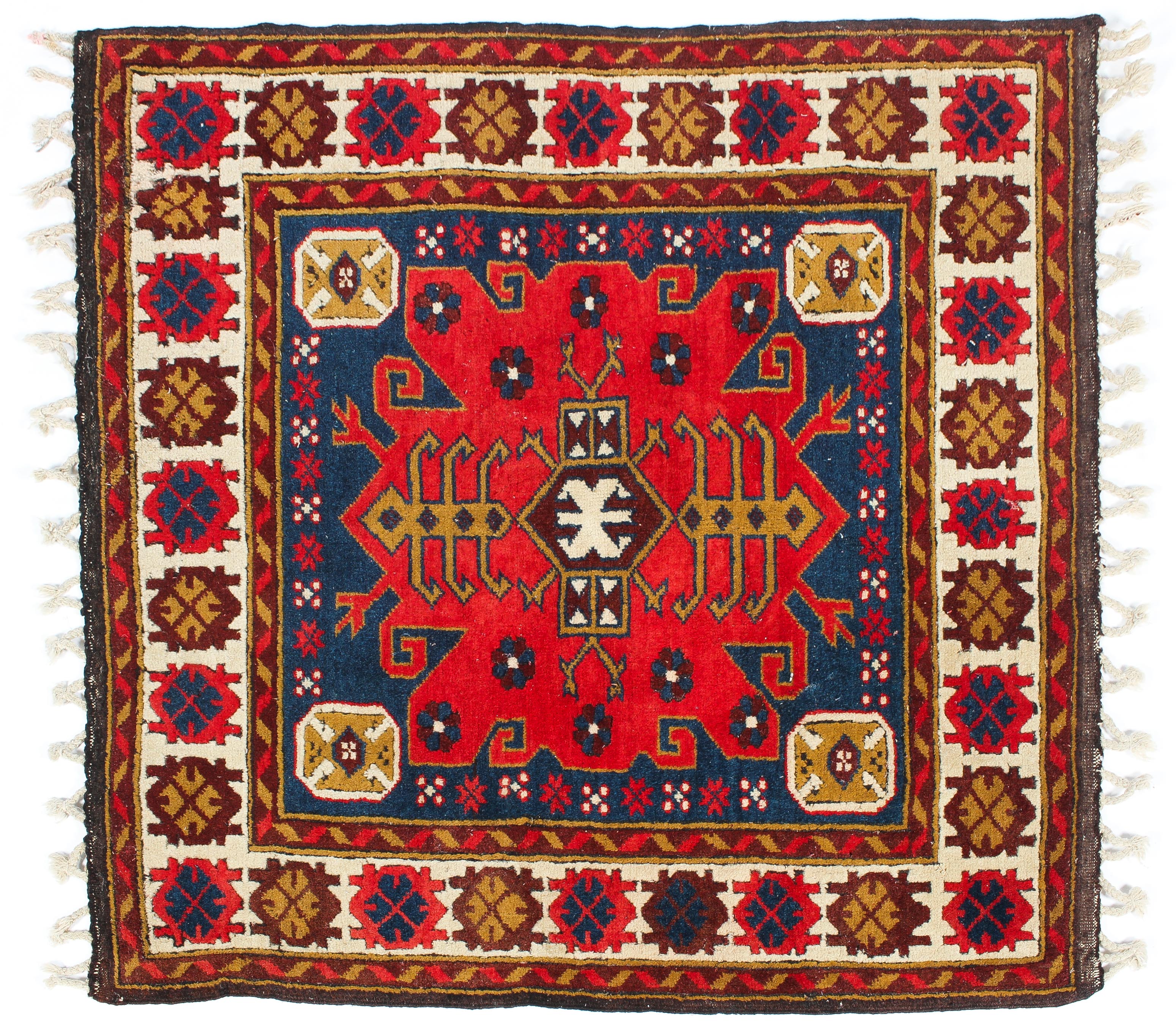 A Kelim style wool rug red ground with typical geometric decoration.