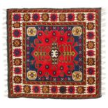 A Kelim style wool rug red ground with typical geometric decoration.