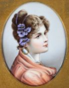 A Continental porcelain oval portrait plaque of a young lady, late 19th century, in glazed frame,