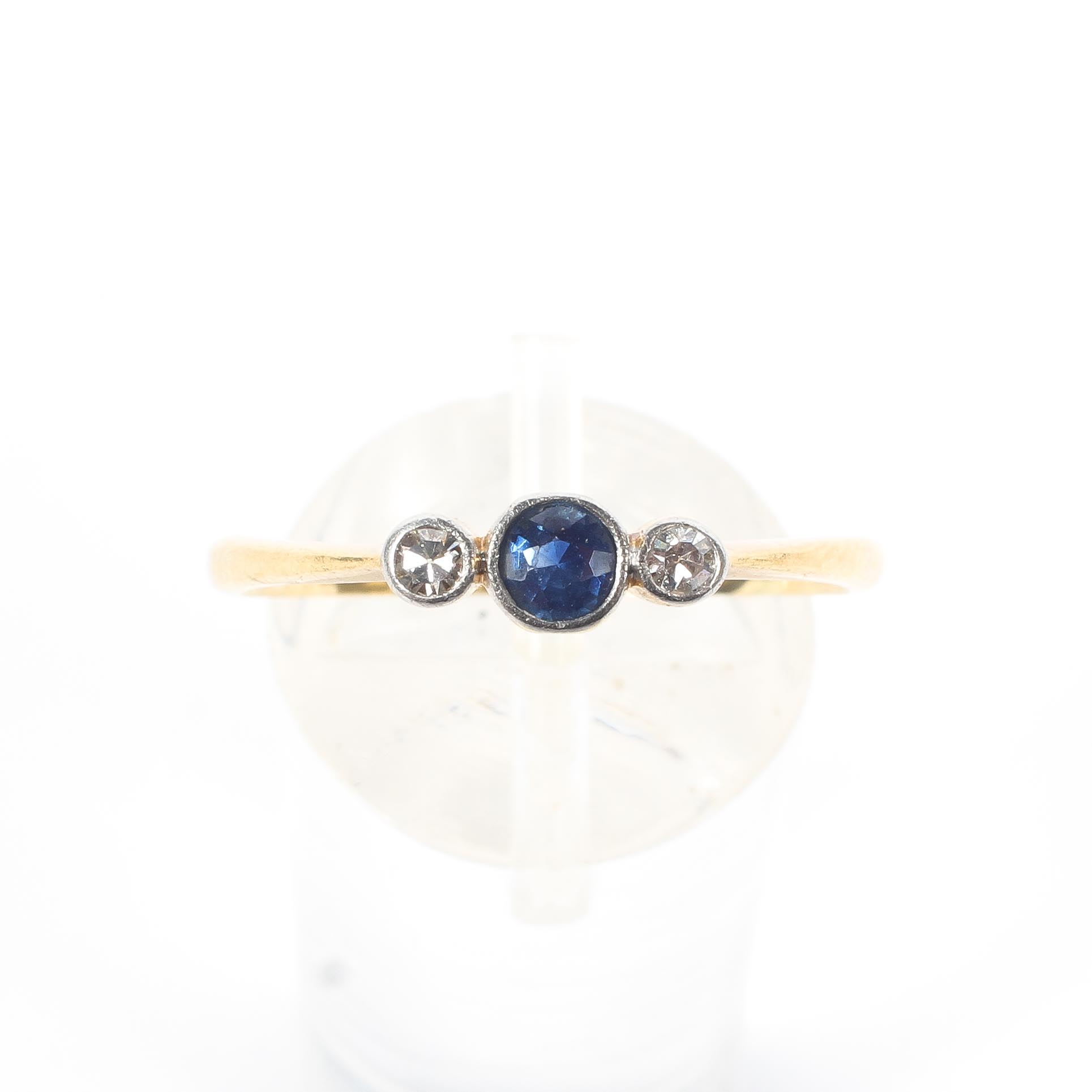 An 18ct gold sapphire and diamond ring, central round cut sapphire with single cut diamond accents. - Image 2 of 5