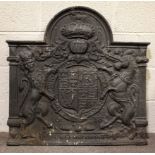 A cast iron antique style fire back, of arched rectangular form, cast with the Royal Arms,