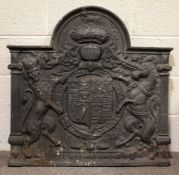 A cast iron antique style fire back, of arched rectangular form, cast with the Royal Arms,