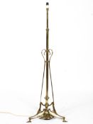 An Art Nouveau brass floor lamp in the manner of WAS Benson, circa 1900, adapted for electricity,