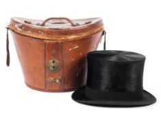 A Tress & Co London black top hat in fitted red velvet lined leather travel case.