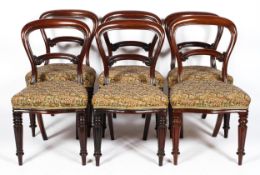 A set of six Victorian mahogany balloon-back dining chairs, with carved foliate back rest,