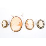 Four shell cameo brooches in unmarked yellow metal mounts.