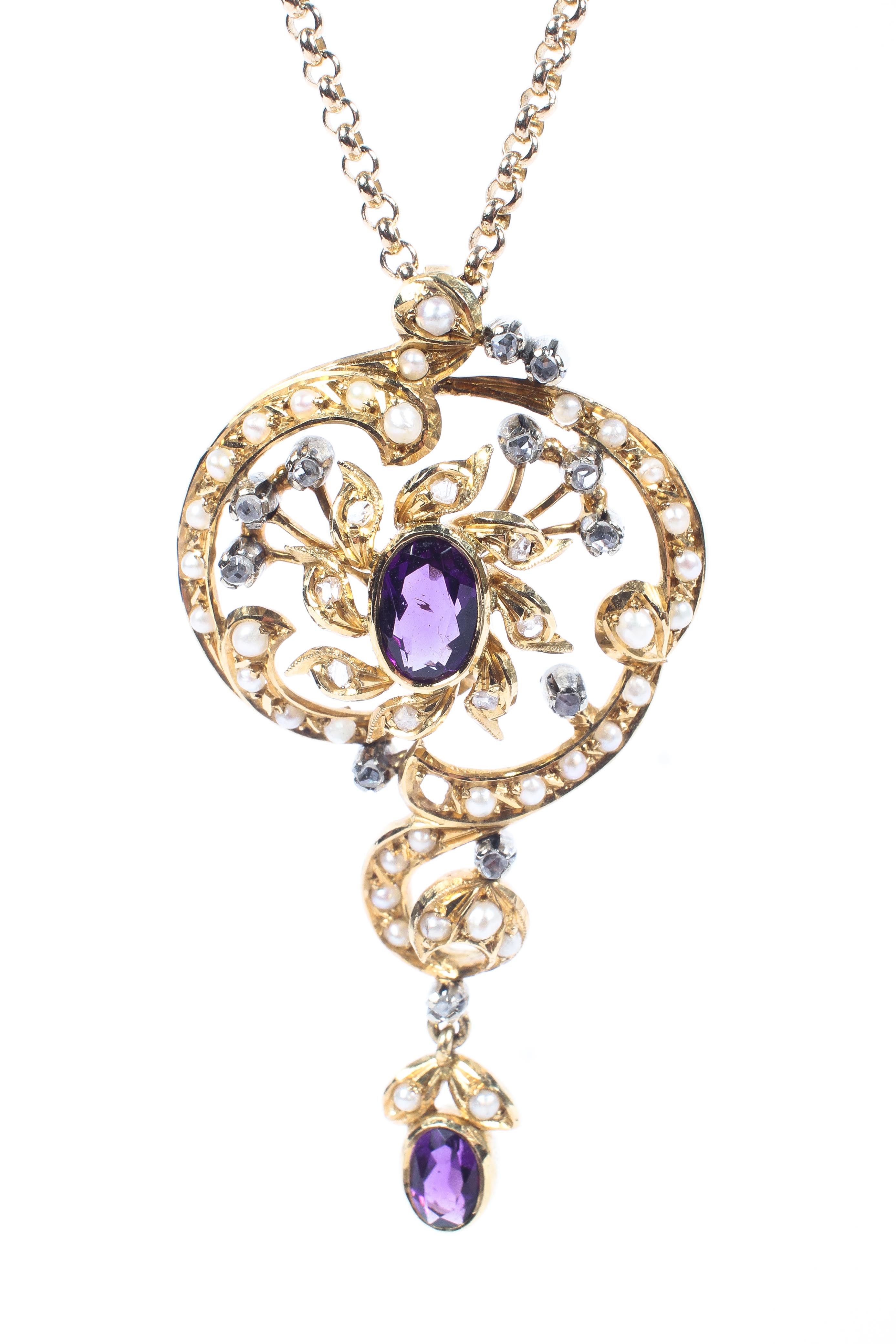 An unmarked yellow metal pendant set with central oval amethyst with a surround of seed pearls and