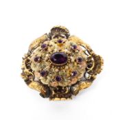 A 19th century unmarked yellow metal and paste set brooch. with quartz aperture to reverse. 9.6g.