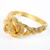 An unmarked yellow metal knot bangle bracelet. 31.3g. Internal 6cm.