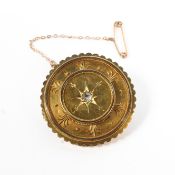 A yellow metal Etruscan style wheel brooch set with central rose cut diamond