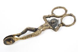 A pair of Commedia dell'Arte harlequin sugar tongs, silver-gilt plated.