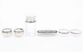 A collection of sterling silver topped glass items to include a perfume bottle by E F Braham Ltd