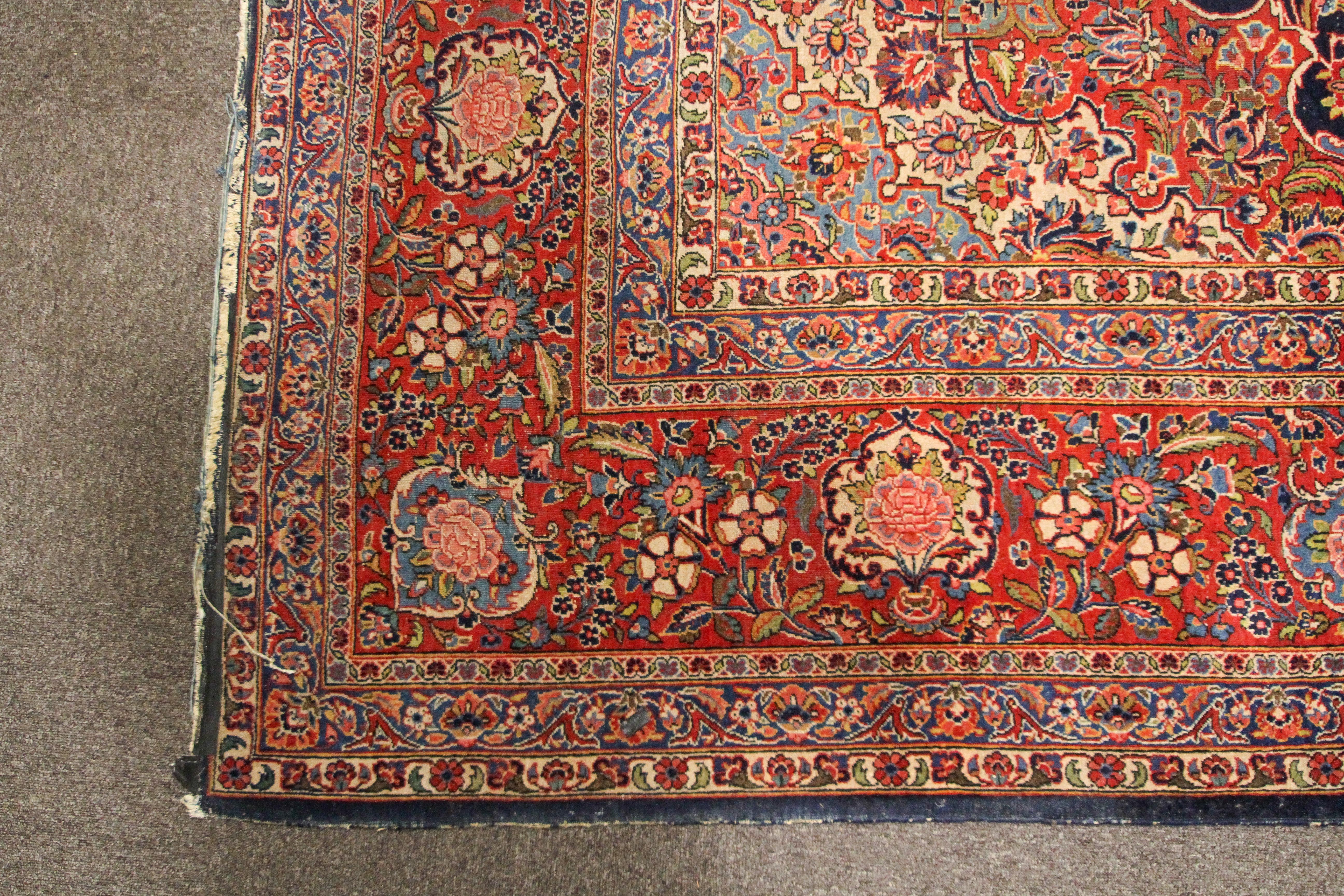 A large Persian silk/wool rug red ground with central floral panel and three floral; borders. - Image 2 of 3