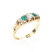 An 18ct gold emerald and diamond ring. 3.4g Size J.