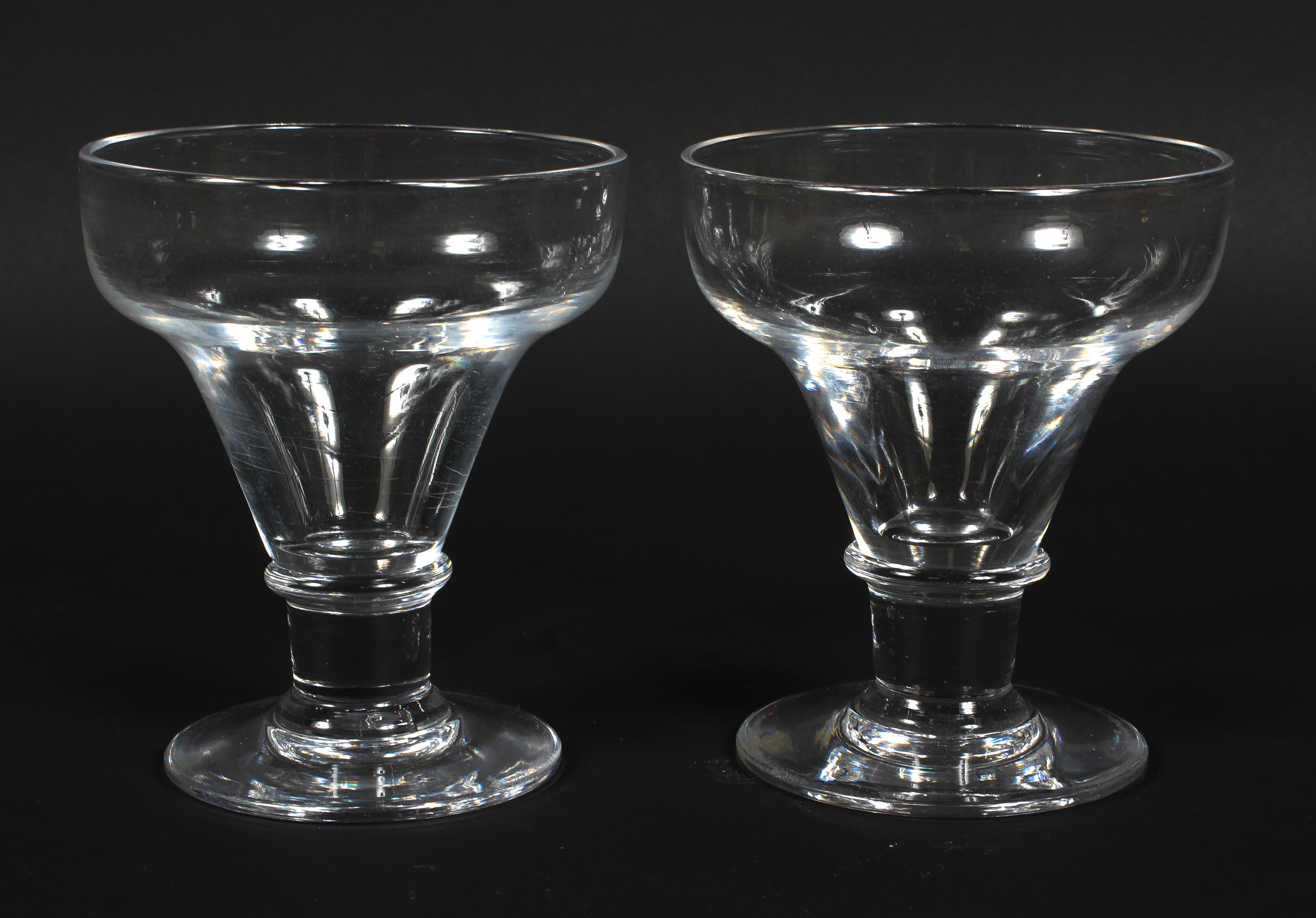 A pair of Georgian glass rummers, each with cup shaped bowl above ring stem, on spreading foot,