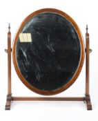A 19th century mahogany oval dressing table swing mirror,