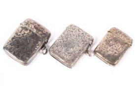 Three Victorian silver vesta cases, each with engraved flowing foliate decoration to the outer,