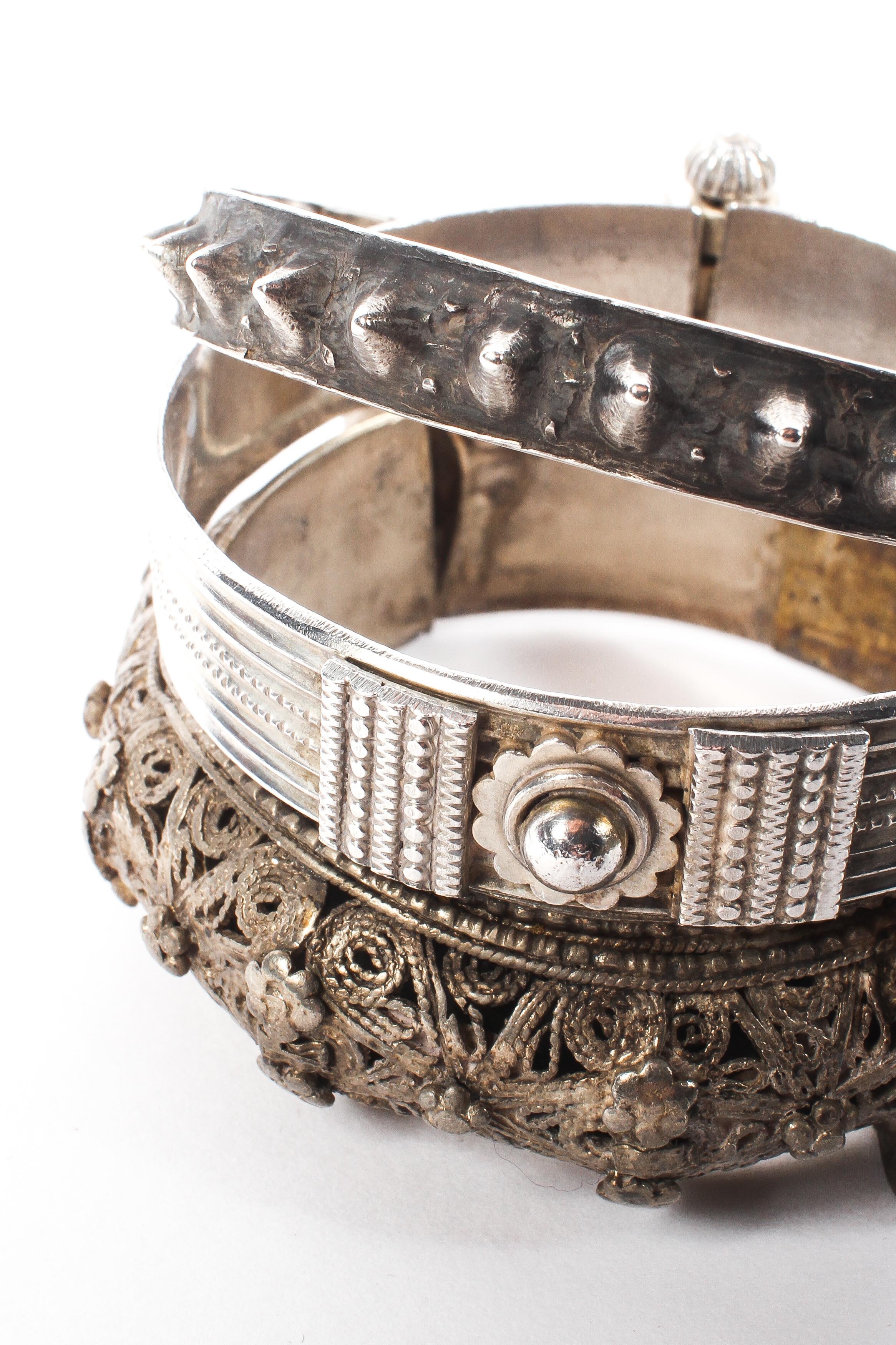 A collection of three Omani style white metal bangle bracelets. 133g. - Image 2 of 2