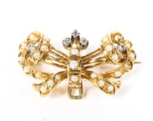 A yellow metal diamond and seed pearl bow brooch. 6.5g.
