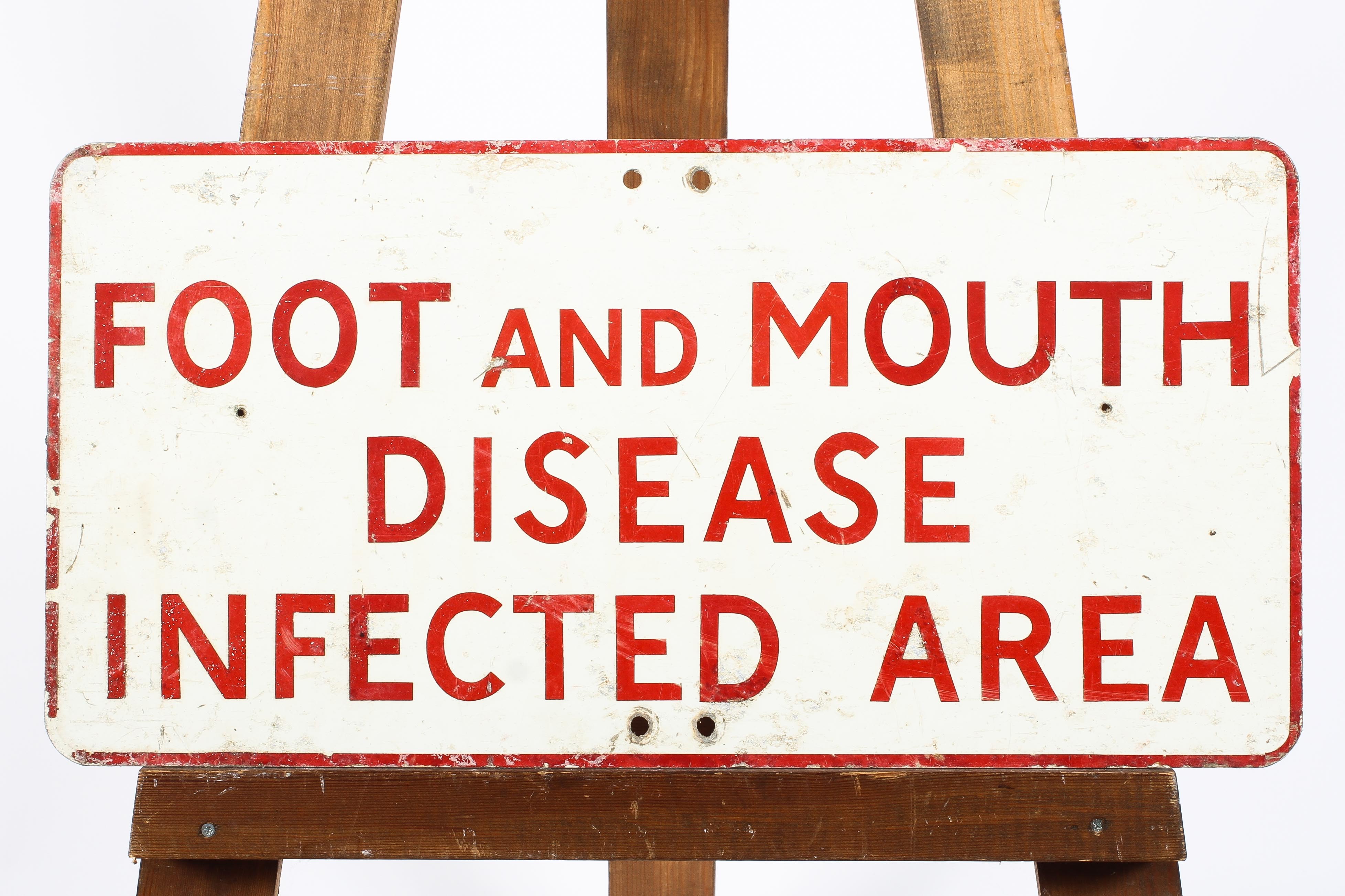 A rectangular enamel sign in red and white reading 'Foot and Mouth Disease Infected Area',