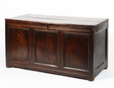 An oak 17th/18th century panelled coffer, the front with three moulded panels, on stile legs,