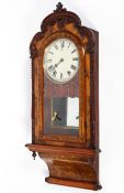 A Seth Thomas burr walnut striking wall clock, inlaid with stringing,