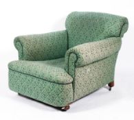 A Howard style armchair upholstered in green floral print,