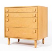 A Meredew retro pale oak chest of drawers, with four graduated drawers, on cylindrical feet,