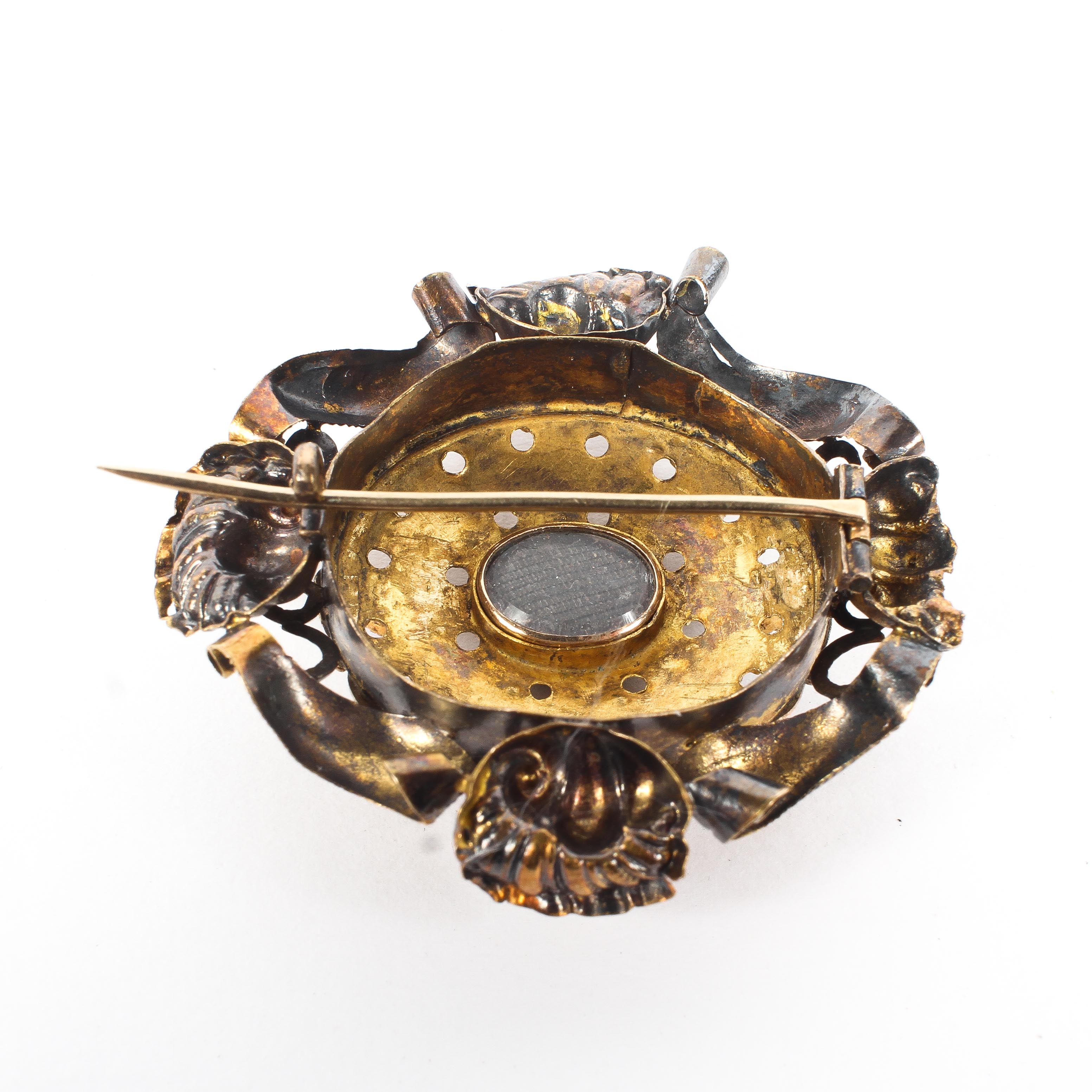 A 19th century unmarked yellow metal and paste set brooch. with quartz aperture to reverse. 9.6g. - Image 2 of 3
