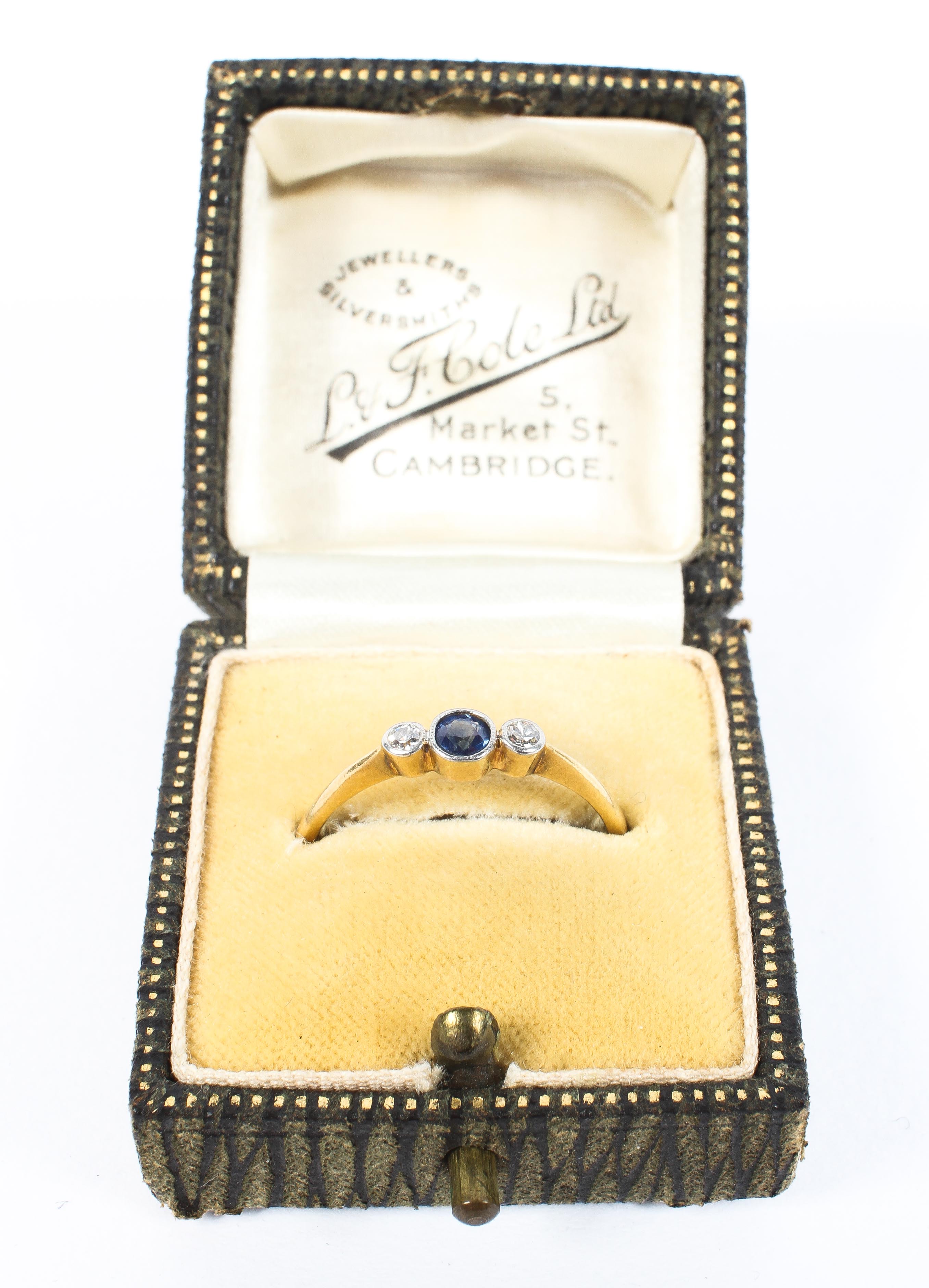 An 18ct gold sapphire and diamond ring, central round cut sapphire with single cut diamond accents. - Image 5 of 5