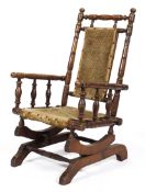 An Edwardian child's rocking chair, with turned reeded spindles and uprights,