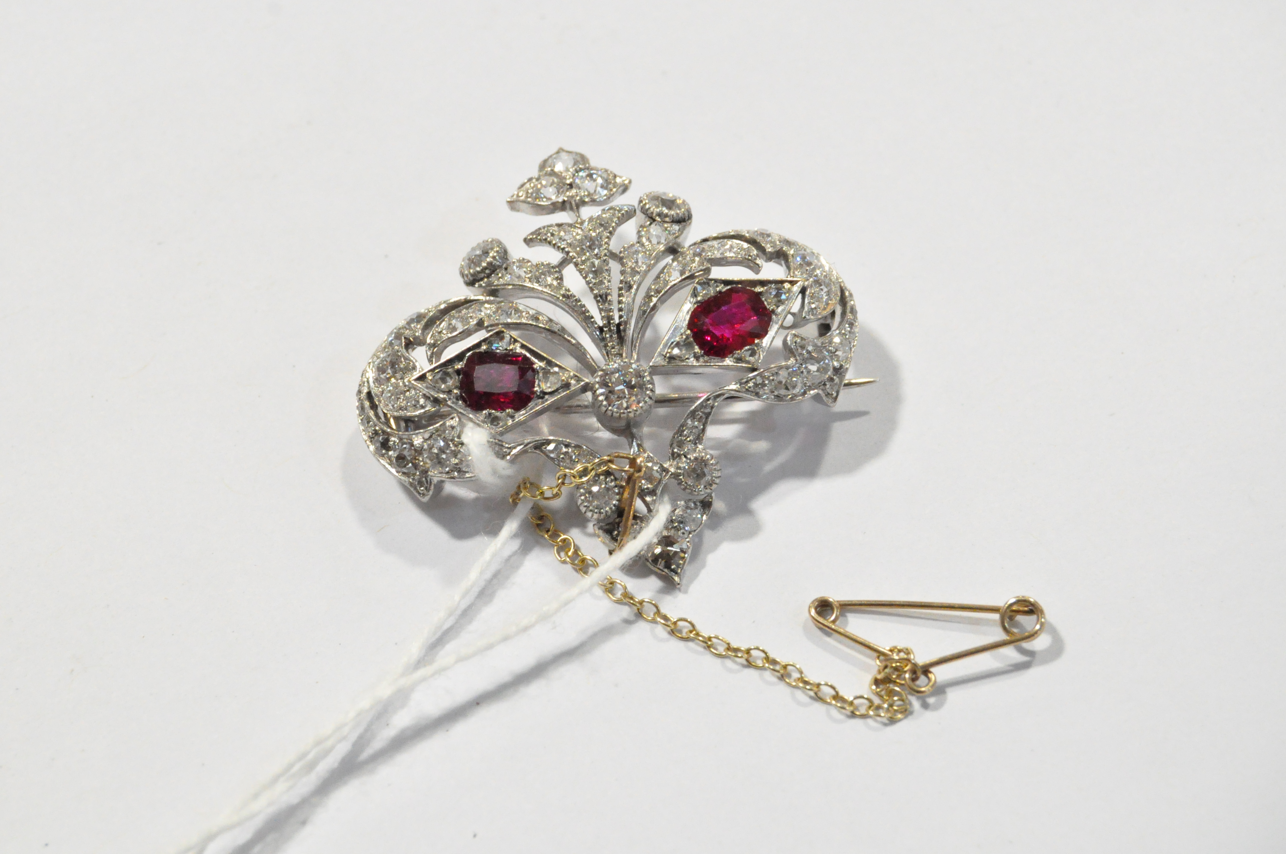 An unmarked white metal ruby and diamond brooch with two cushion cut rubies - Image 3 of 7