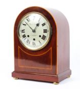 A 20th century mahogany dome topped mantel clock, the silvered dial with Roman numerals,