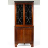 A Georgian mahogany corner cupboard, the double glazed doors enclosing two scroll edged shelves,