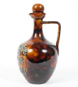 A Doulton Lambeth stoneware Melrose Highland Whisky jug and stopper, late 19th century,