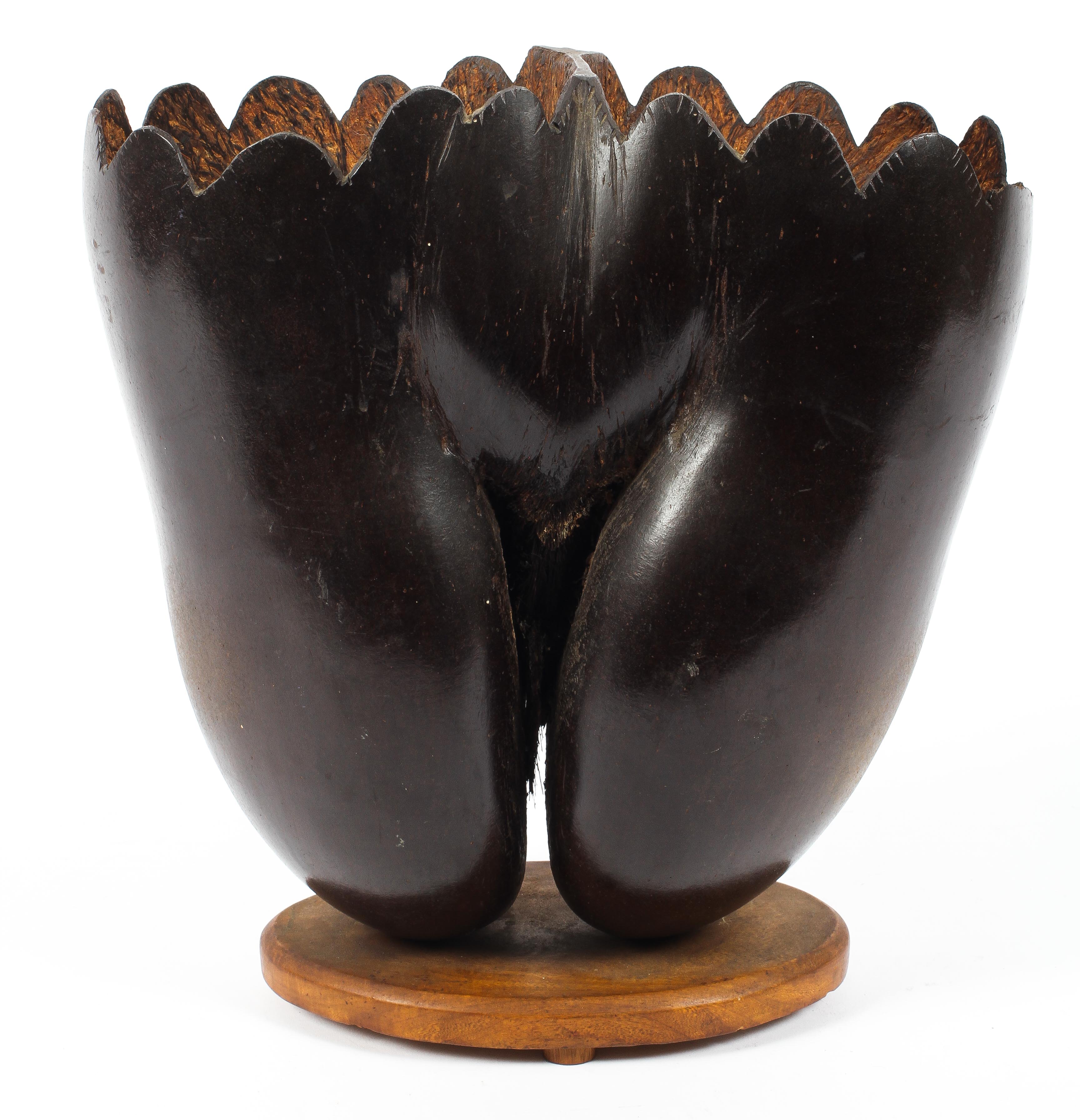 An early coco de mer nut, Lodoicea maldivica carved as a two section basket on oval stand.