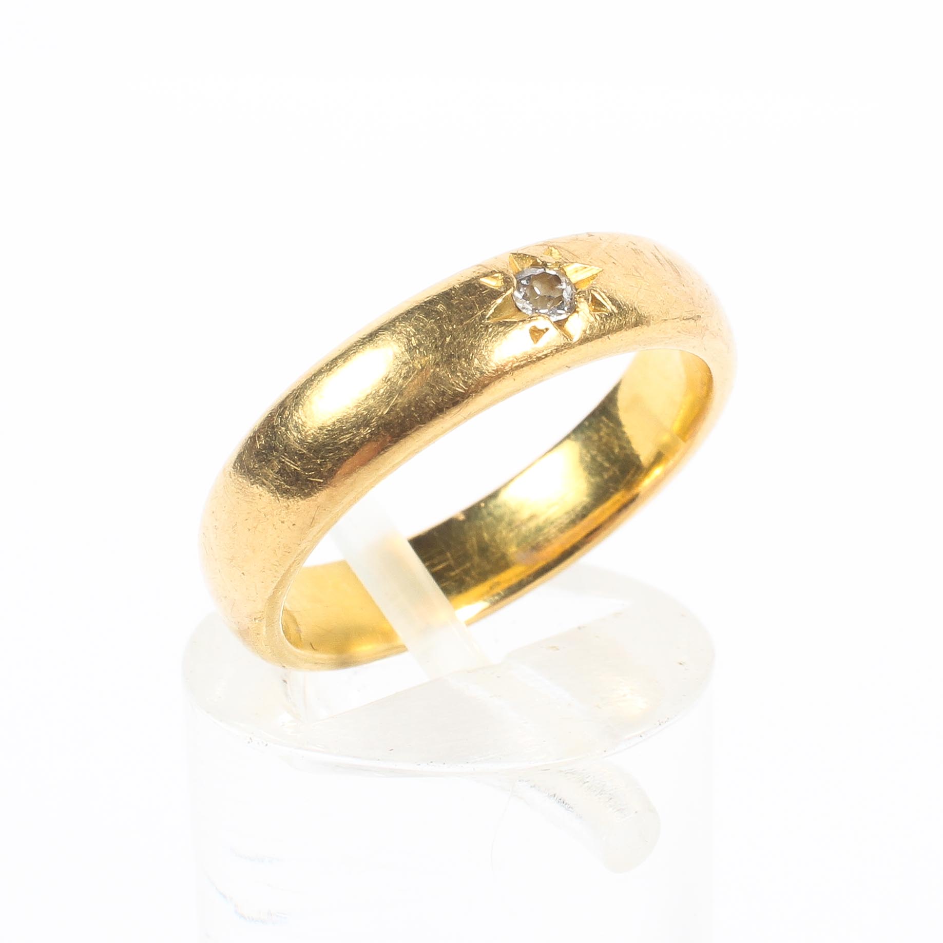 A 22ct gold diamond set wedding band. 5.8g. size K.