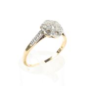 An 18ct gold and platinum flower ring. Set with seven single cut diamonds. 2.1g. Size M.